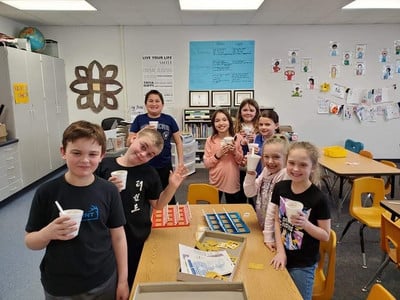 elementary students enjoying ice cream party and board games