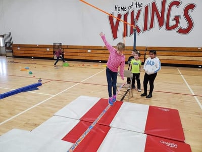 Elementary students enjoying activities in the gym